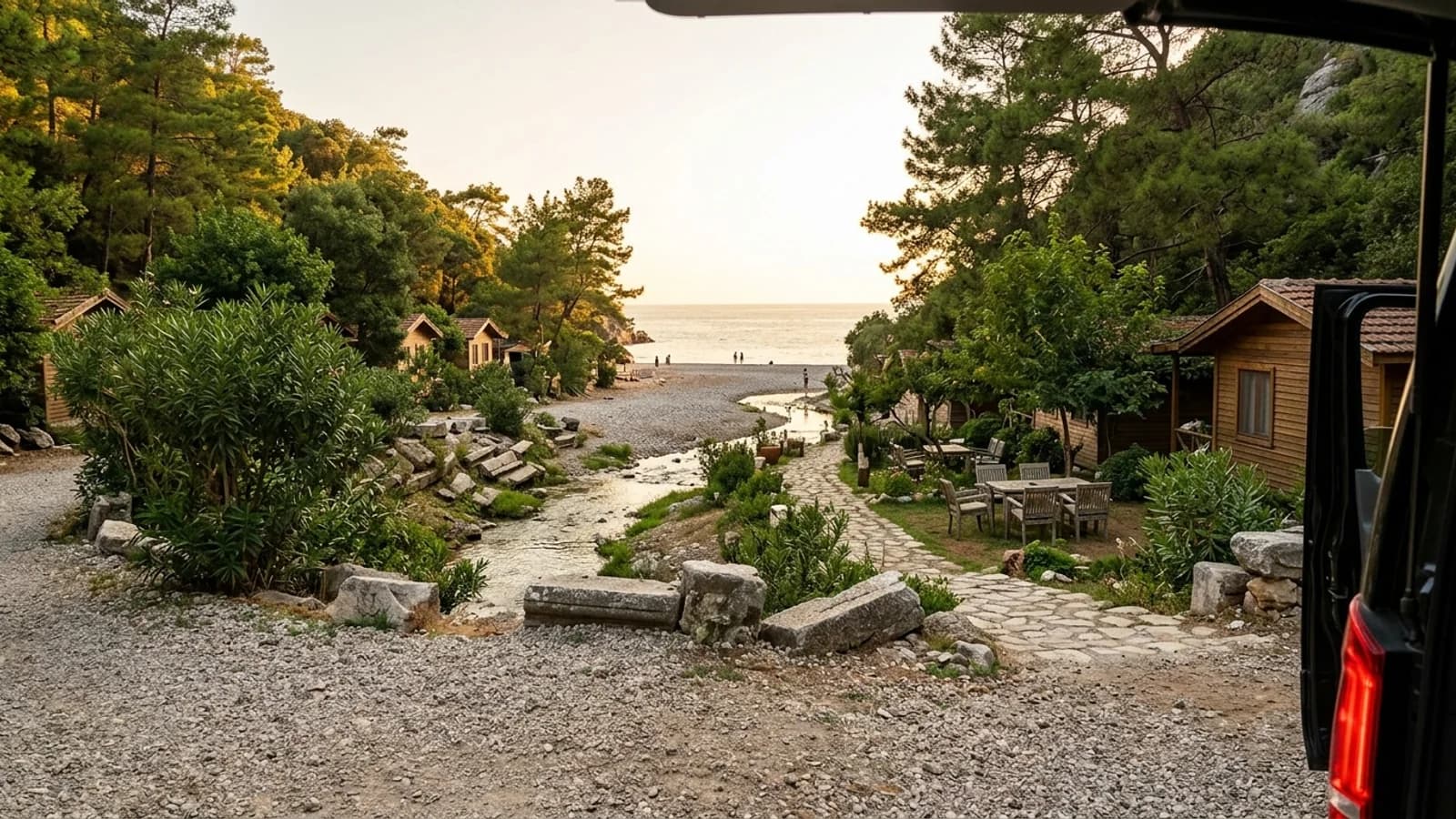 Olympos beach and ancient ruins A wooded river valley with ancient ruins and wooden bungalows opens onto Olympos pebble beach.