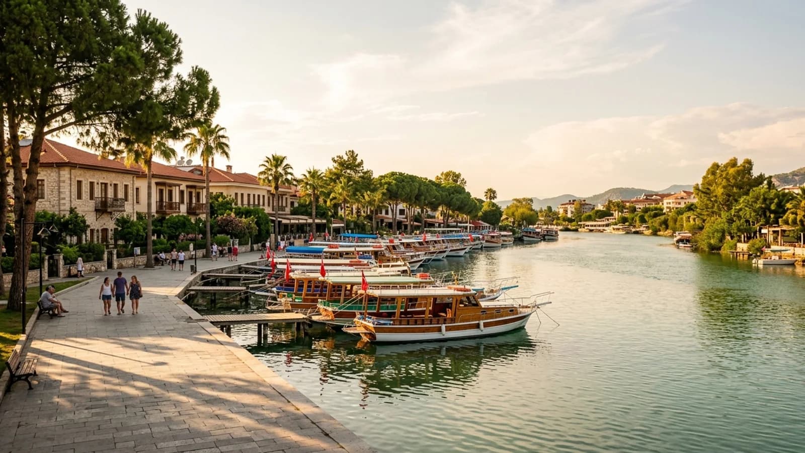 Деревянные лодки на реке Манавгат Широкая зеленая река Манавгат медленно течет мимо разноцветных деревянных лодок, пришвартованных у берегов с деревьями.